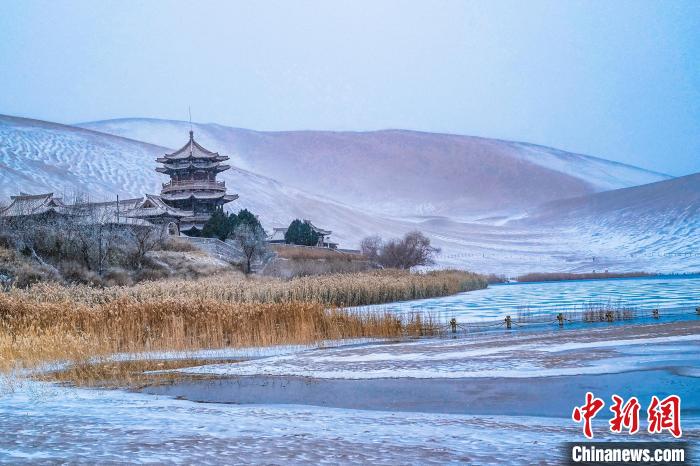 2021年11月28日，雪落鳴沙山月牙泉景區(qū)?！⊥醣筱y 攝