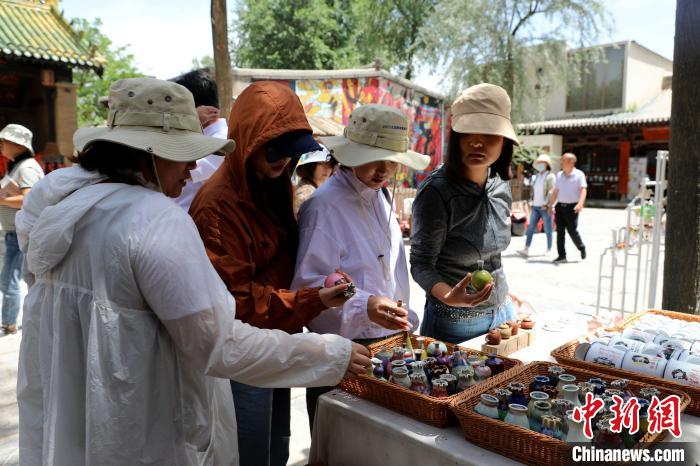 圖為民眾挑選手工藝產(chǎn)品?！⊙Φ?攝